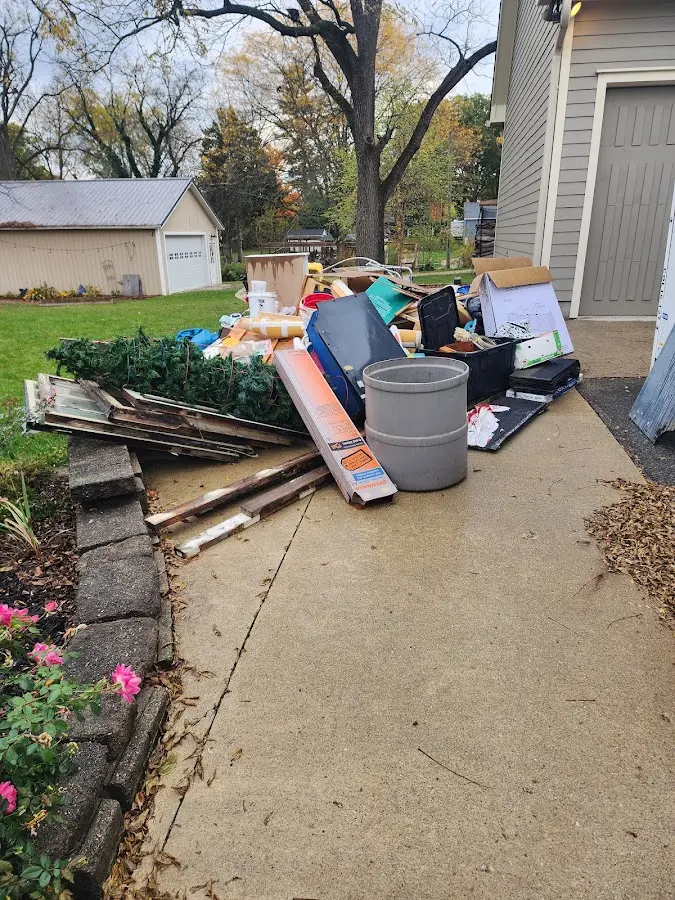 Dumpster being loaded with debris for Estate Cleanout Dumpster Rental in Ashdown